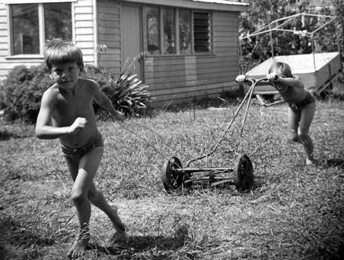 Boys mowing the lawn, 1970