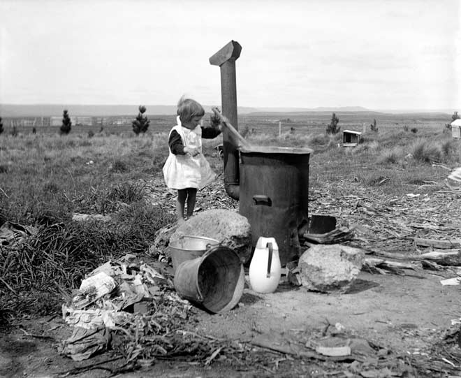 Child stirring a copper, 1910