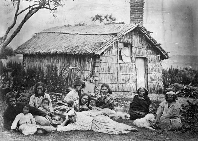 Family outside their whare