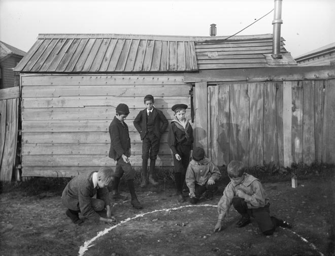 Boys playing marbles, around 1900