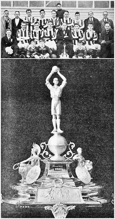 Seated team photo, with men in stripped black and white football uniforms and men in suits. At the feet of the team are three boys and a silver trophy. Below is a closeup of the silver trophy.  