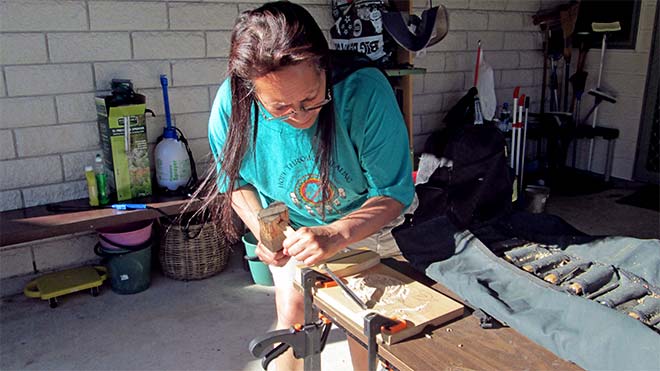 Woman carving graduate of Maunga Kura Toi
