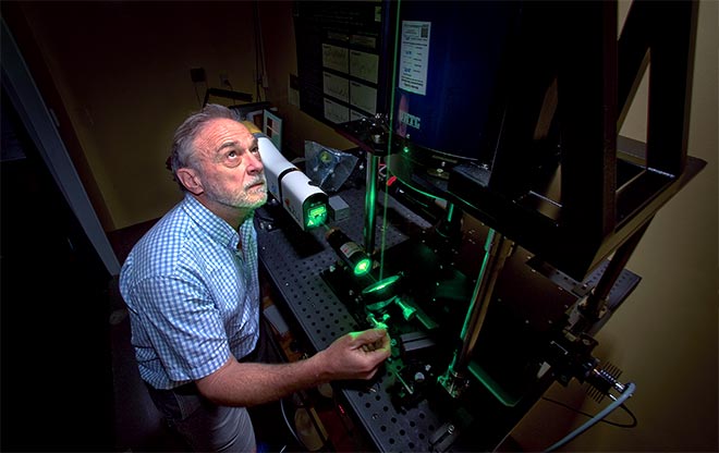 NIWA physicist Ben Liley adjusts a LIDAR 