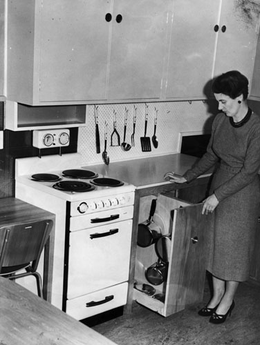 Home science tutor Emily Elizabeth Carpenter in a demonstration kitchen, 1956