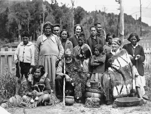 A group photograph in an outdoor setting of Annie Henry with a group of Maori 