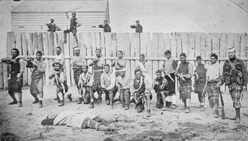 Thomas William Porter (right) and pro-Government Māori troops outside a stockade, 1870