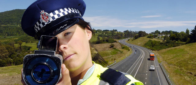 A police officer using a laser speed camera, 2009