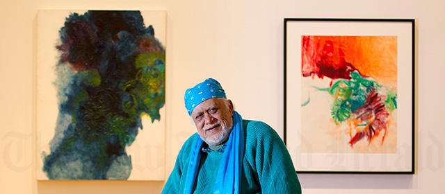 Cook Islands artist Paul Tangata with two of his paintings, 2012