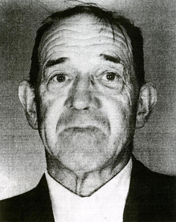 Portrait photograph of elderly man wearing suit jacket and white collared shirt