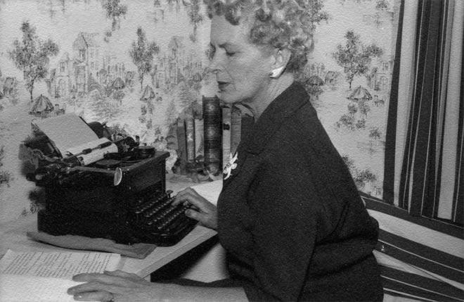 At her typewriter