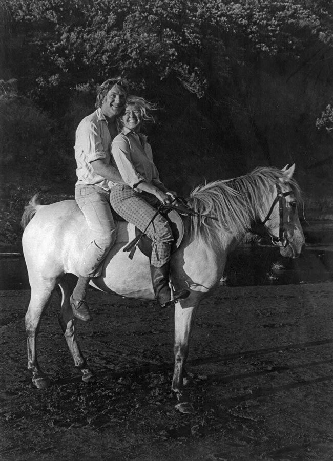 Harry and Nan Turbott together on horseback, smiling happily. 