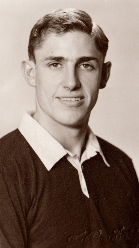 A studio portrait of Murray Ball as a young man wearing a rugby jersey.