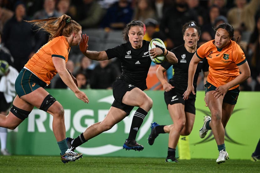 New Zealand women's rugby player Ruby Tui trying to evade Australian opponents during 2021 rugby world cup game.