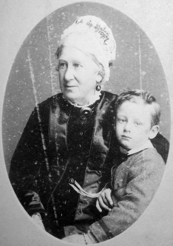 Elderly woman seated next to young boy.
