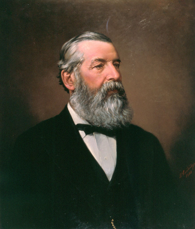 A head and shoulders portrait of Julius Haast in later life, heavily bearded, in suit and bow tie.