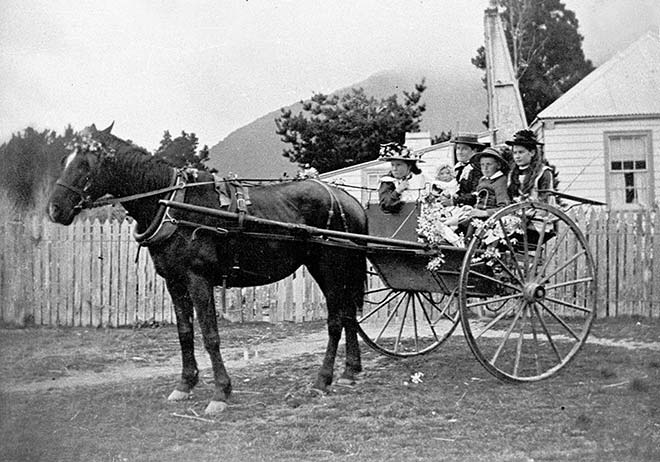 Catherine Adamson and her children enjoy a ride on a decorated buggy at Whataroa, South Westland