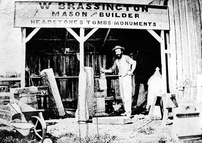 William Brassington standing in the doorway of his stonemason's workshop