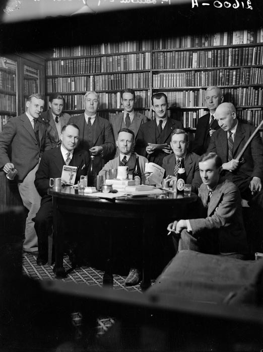 Eleven Wellington writers meeting in a study