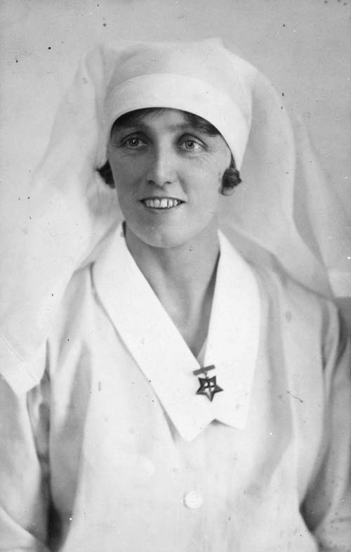 Gladys Tompkins wearing her nurse's uniform and registration medal in the late 1920s or 1930s
