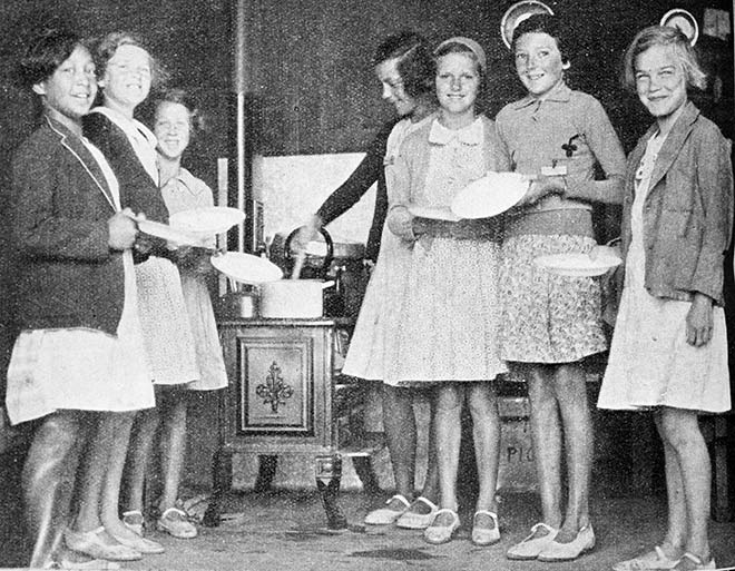 Girls at the Sunlight League's Christchurch health camp line up for porridge, January 1936
