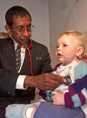 Dr Upali Manukulasuriya with a young patient