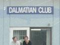 Two people and car in front of the Dalmatian club
