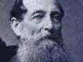 A photograph of Thomas Grace seated at a desk