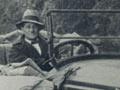 Jack Musgrave at the wheel of a service car in the Waimana Gorge, Bay of Plenty, probably after 1918
