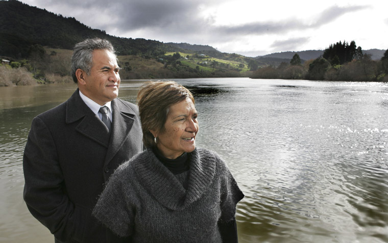 A man and a woman in front of the Waikato River
