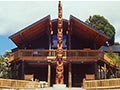 Large visitors centre with a central pou with Maori carvings and large verandahs. 