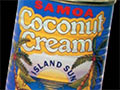 A colour advertisement for coconut cream, displaying cans of coconut cream and a coconut tree