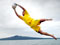 Person leaping to save ball with Rangitoto island in background
