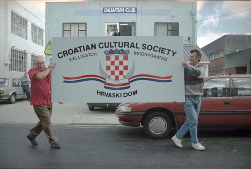 Two people and car in front of the Dalmatian club