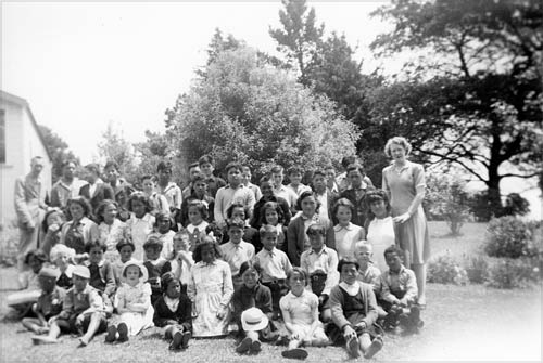 Class photograph on lawn in front of school