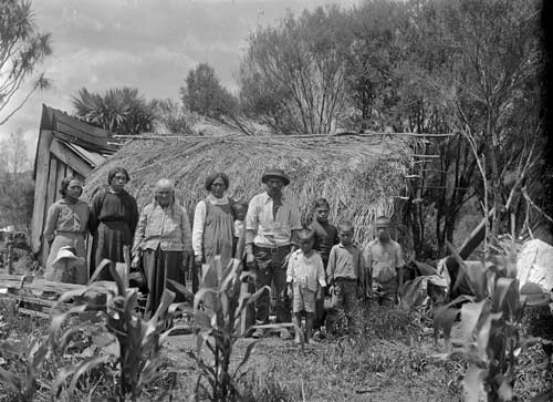 Whānau outside a whare