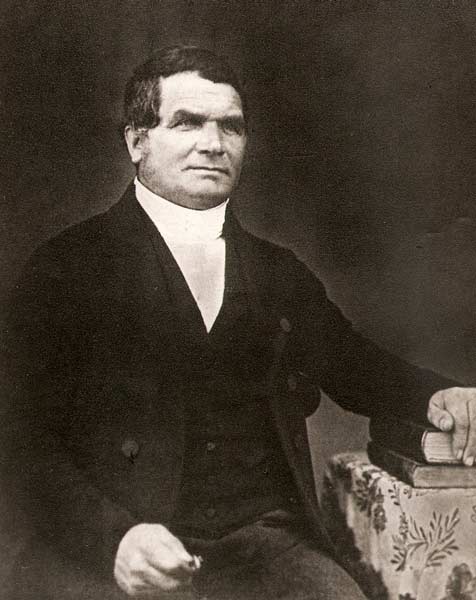 A photograph of James Kemp in a seated position