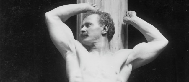 Bodybuilder with arms raised showing muscles