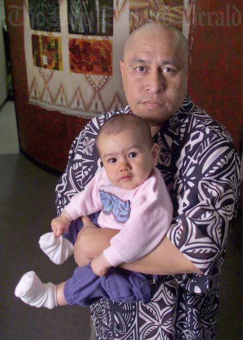Pacific man holding a baby