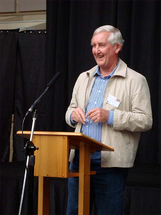 Man standing at lectern on stage