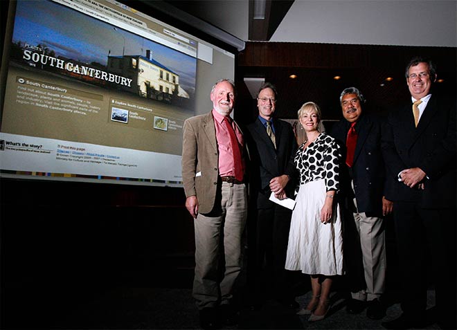 Four men and one woman on stage with 'South Canterbury' webpage on screen behind 