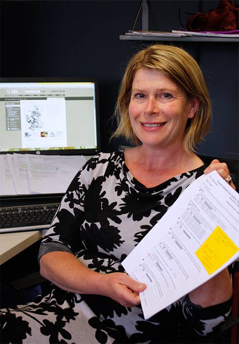 Caren Wilton holding paper with yellow sticky