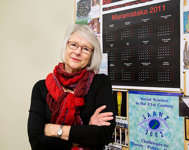 Woman in scarf standing next to Maramataka 2011 calendar