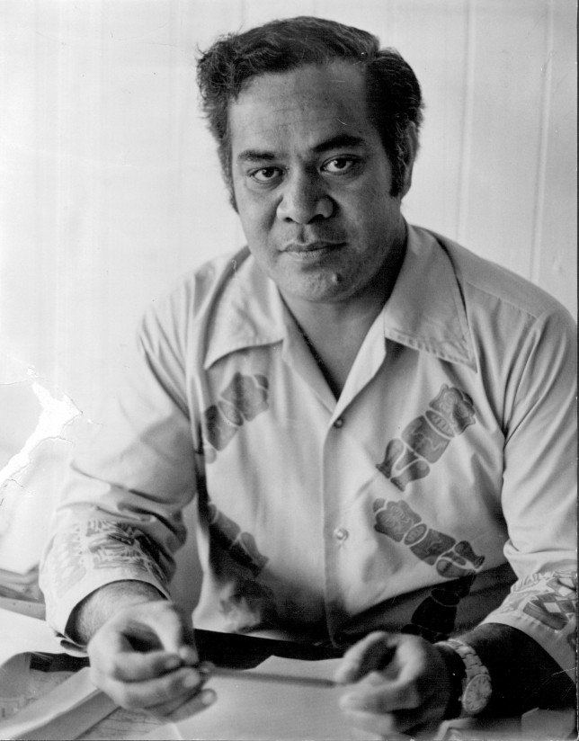 Pacific man in collared shirt sitting at desk