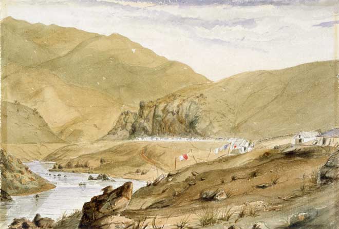 Painting of river and small houses in a brown landscape.