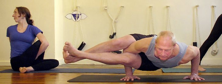 Grey-haired man doing yoga pose