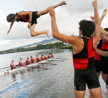 Hamilton Boys’ High School rowers throw their cox into Lake Karapiro after winning the Maadi Cup