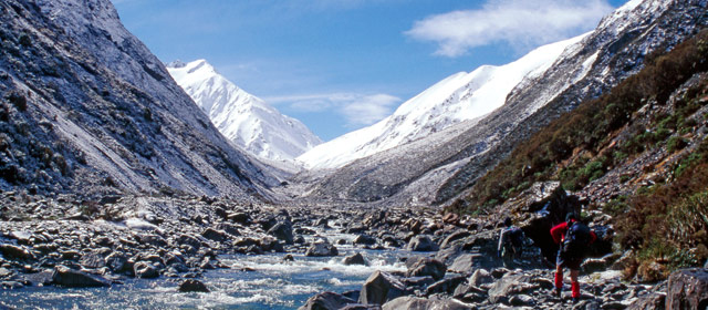 Tramper walking up the Lauper Stream towards Whitcombe Pass