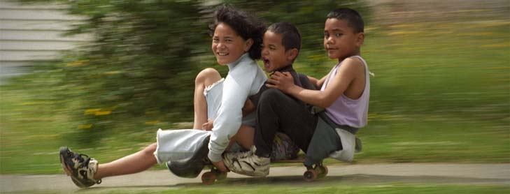 Three kids on a skateboard