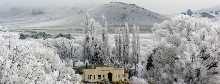 Art deco building surrounded by snow covered trees and fields