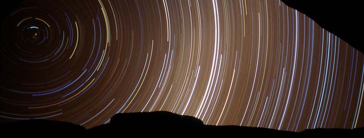 Time-lapse image of lines of light across sky
